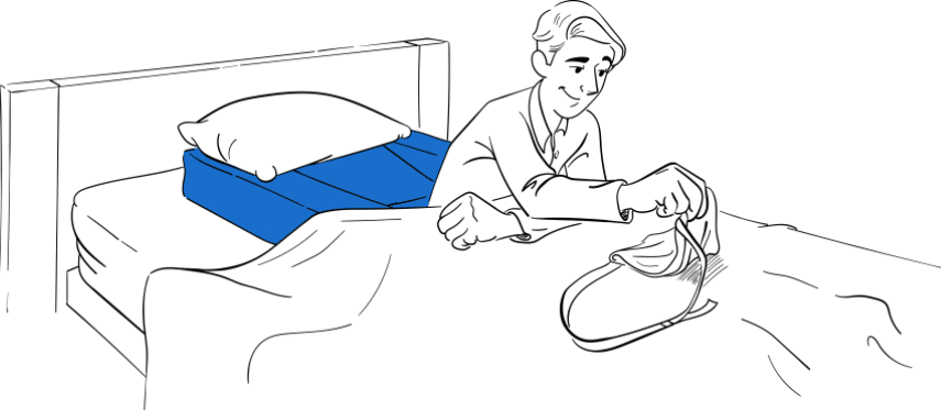 Patient with arm sling easily setting up Restore You shoulder surgery recovery support on bed